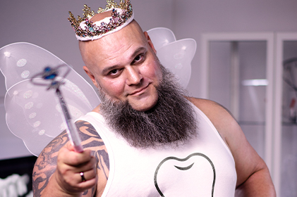 The DMG tooth fairy: a strong man with a beard, a magic wand, fairy wings and a skirt. 