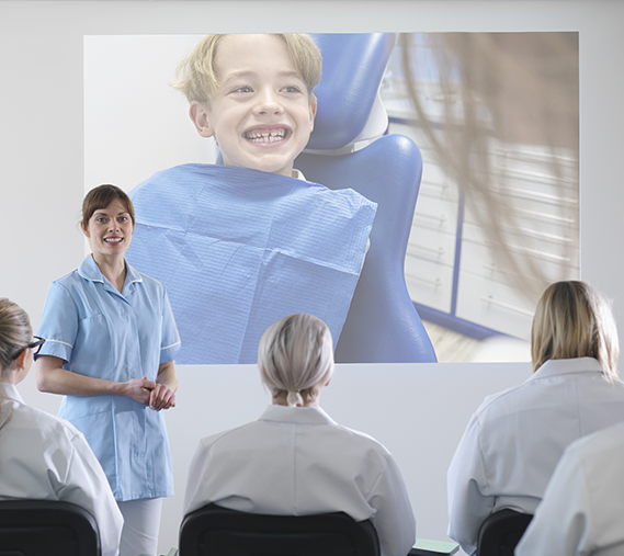 Female speaker standing in front of an audience